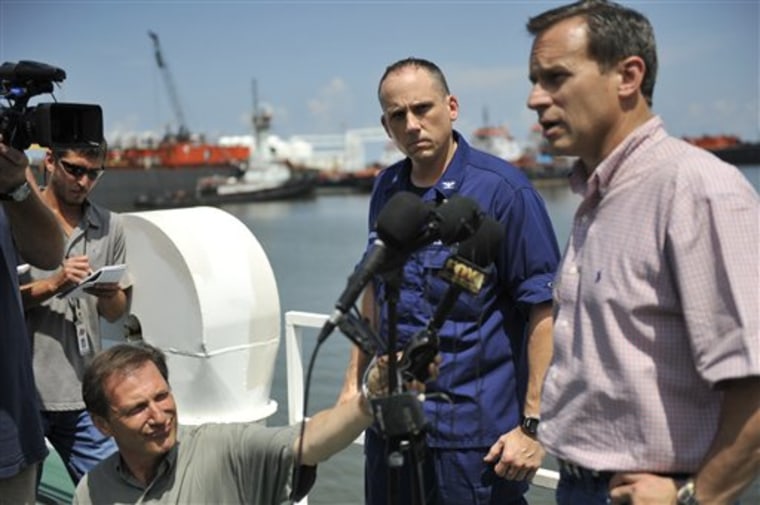 In this June 1, 2010 photo released by the U.S. Coast Guard, Coast Guard Capt. Roger Laferriere, left, incident commander, looks on as Doug Suttles, BP chief operating officer, conducts a news conference in Port Fourchon, La. Laferriere oversees the Houma Incident Command Post coordinating the unprecedented cleanup of oil off of the Louisiana coast. There are other posts like it in Mobile, Ala., and Miami, but none has more manpower, equipment _ or more of oil mass, as Laferriere and his staff have christened their enemy _ than this base inside what once was a BP training facility for offshore oil production.  (AP Photo/U.S. Coast Guard, Petty Officer 3rd Class Barry Bena)